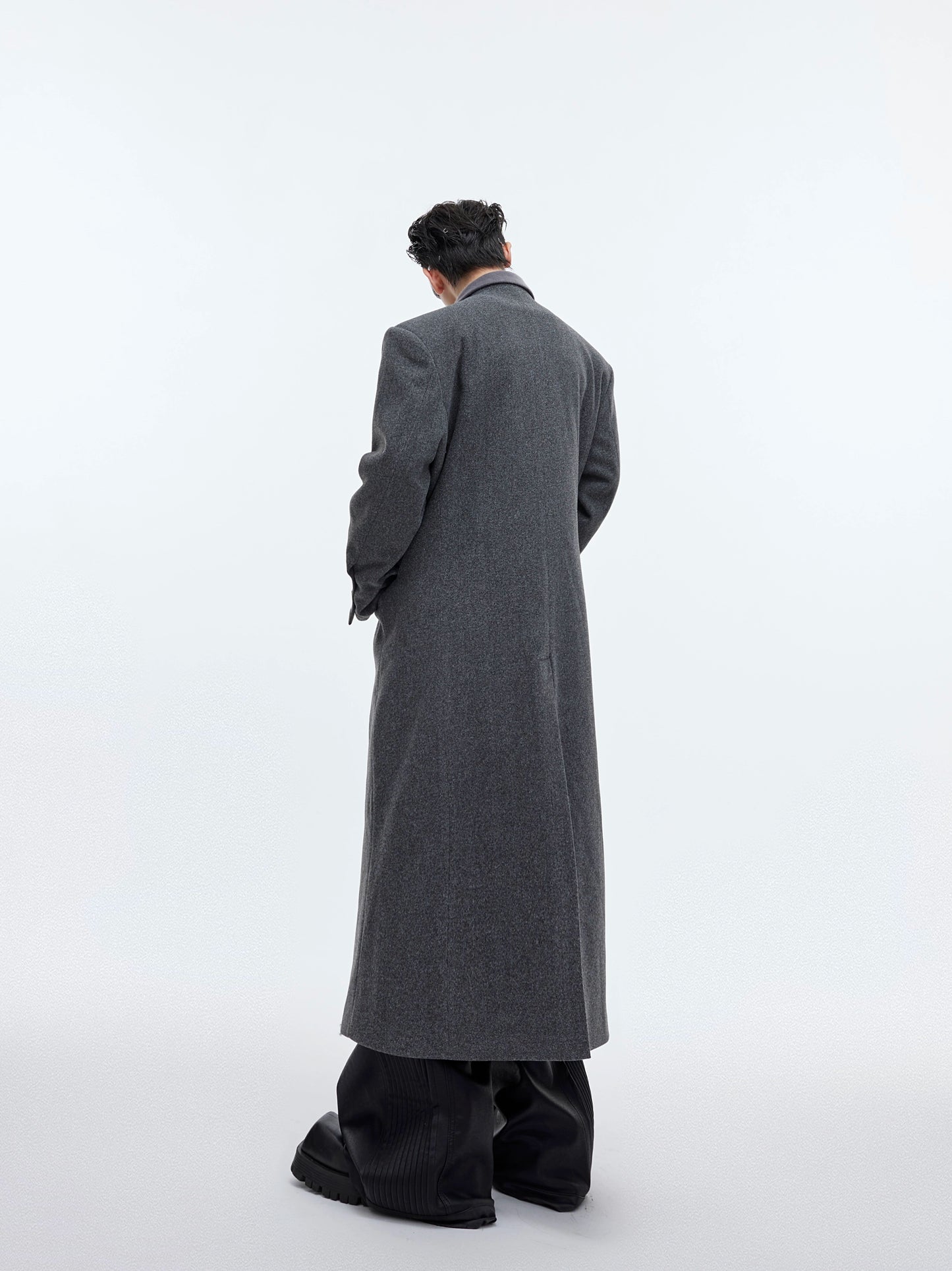 CulturE niche deconstructs the waist-cinching silhouette of a woolen coat with metal buckles and a long over-the-knee tweed jacket