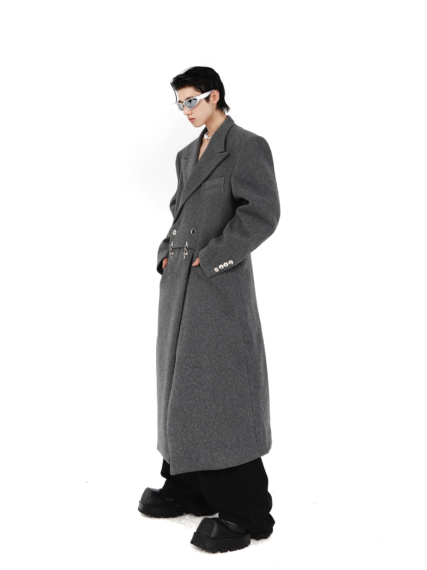 CulturE is a niche deconstructed sculptural silhouette with padded shoulders and a tweed coat with a metal airplane buckle design