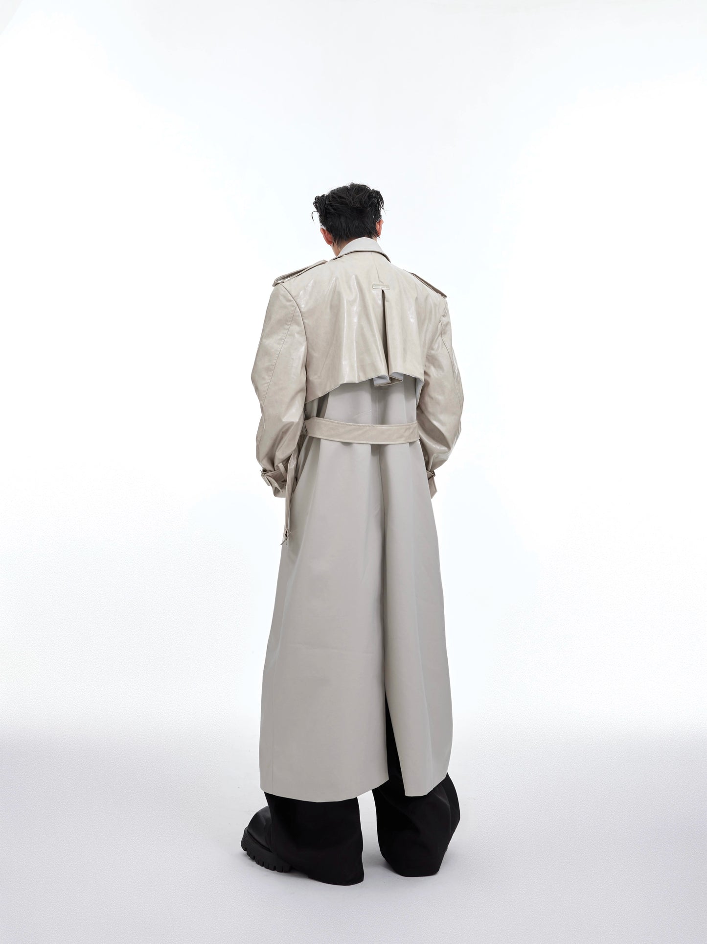 Cultur E24s is a heavyweight, niche deconstructed double-panelled padded-shoulder maxi coat with a breasted trench coat